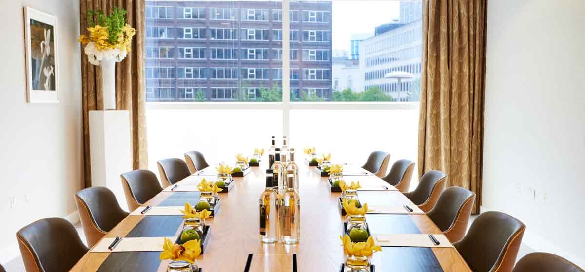 Modern conference room at The Lowry Hotel with elegant wooden table for meetings.