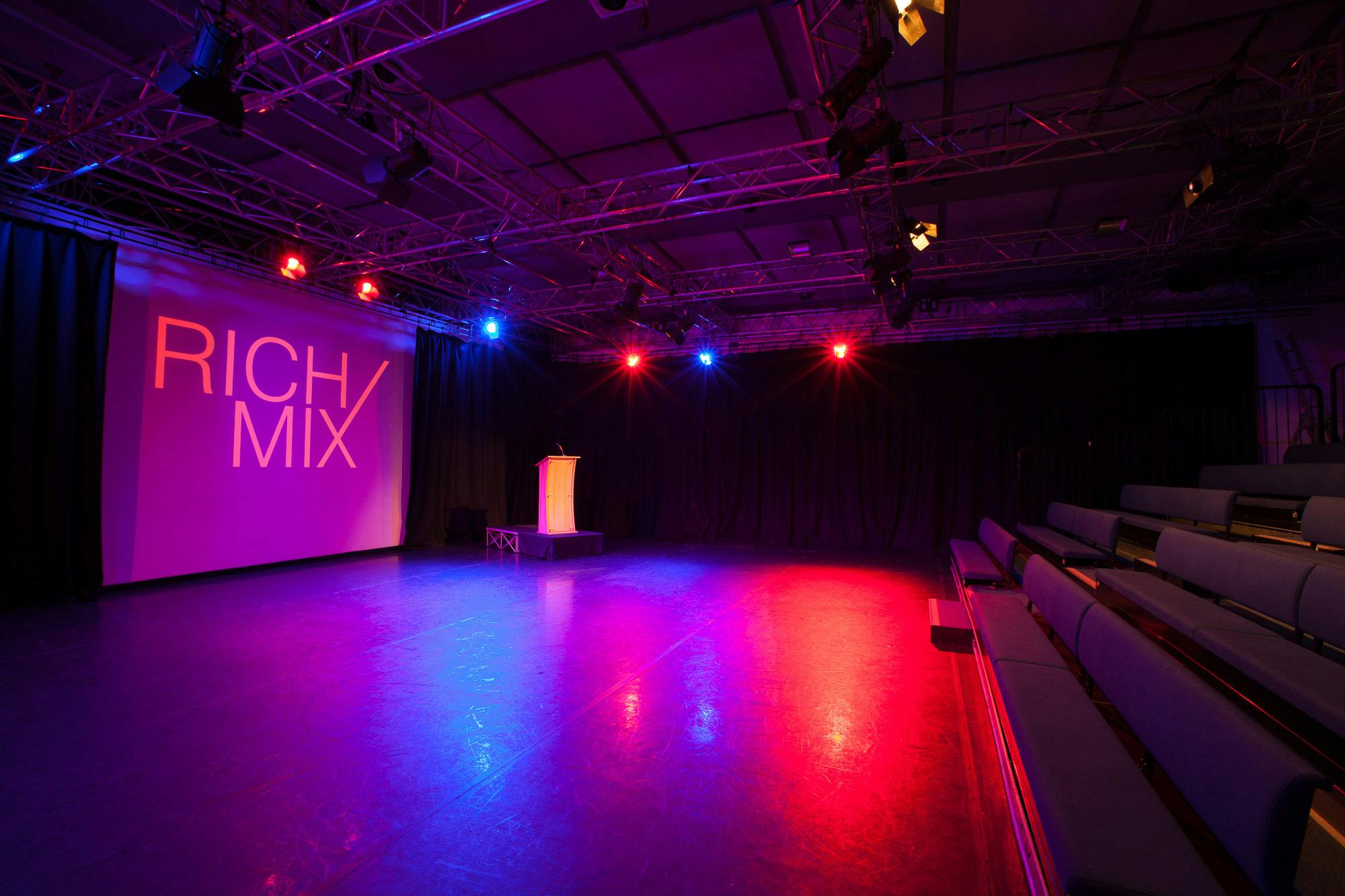 Versatile event space with sleek stage and tiered seating for conferences and performances.