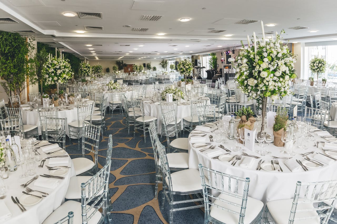 Grand Ballroom at Chelsea Harbour Hotel, elegant wedding venue with floral centerpieces.