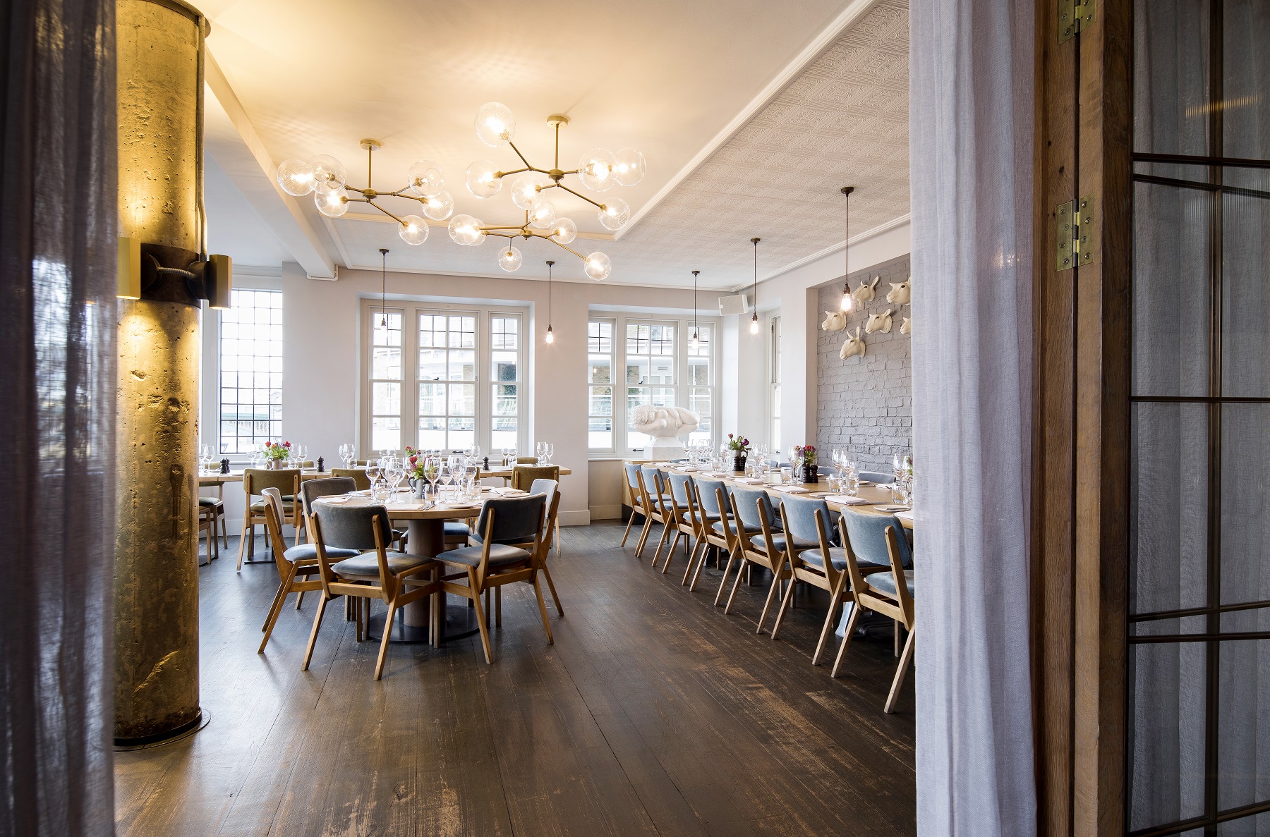 Elegant event space with fine dining setup, perfect for corporate meetings and private celebrations.