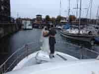 Couple on yacht at The Yacht Club for a romantic wedding venue by the marina.