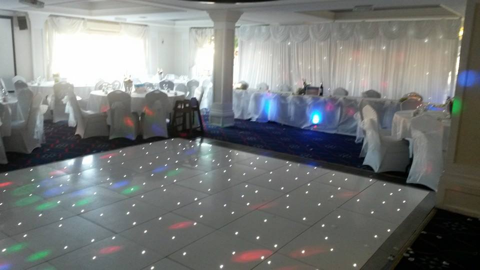 Elegant event space in The Yacht Club with dance floor, ideal for weddings and upscale gatherings. - Banner