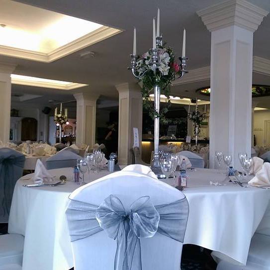 Elegant event space at The Yacht Club with candelabrum centerpiece, ideal for weddings. - Banner