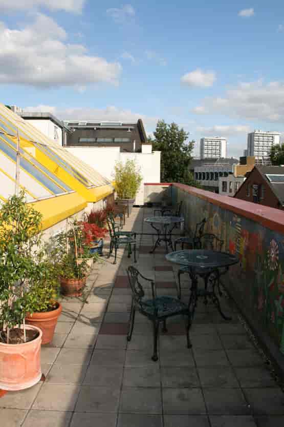 Pyramid Room rooftop terrace with greenery, ideal for casual meetings and networking events.