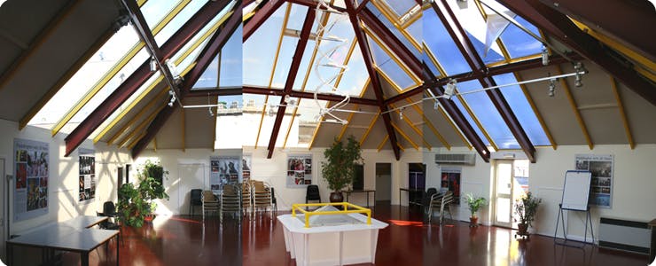 Spacious Pyramid Room with glass ceiling, perfect for corporate events and social gatherings.