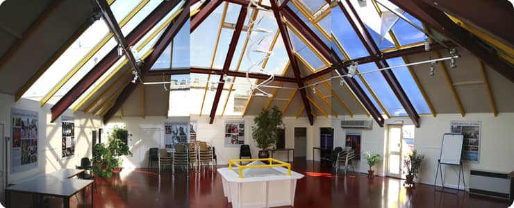 Spacious Pyramid Room with glass ceiling, perfect for corporate events and social gatherings.
