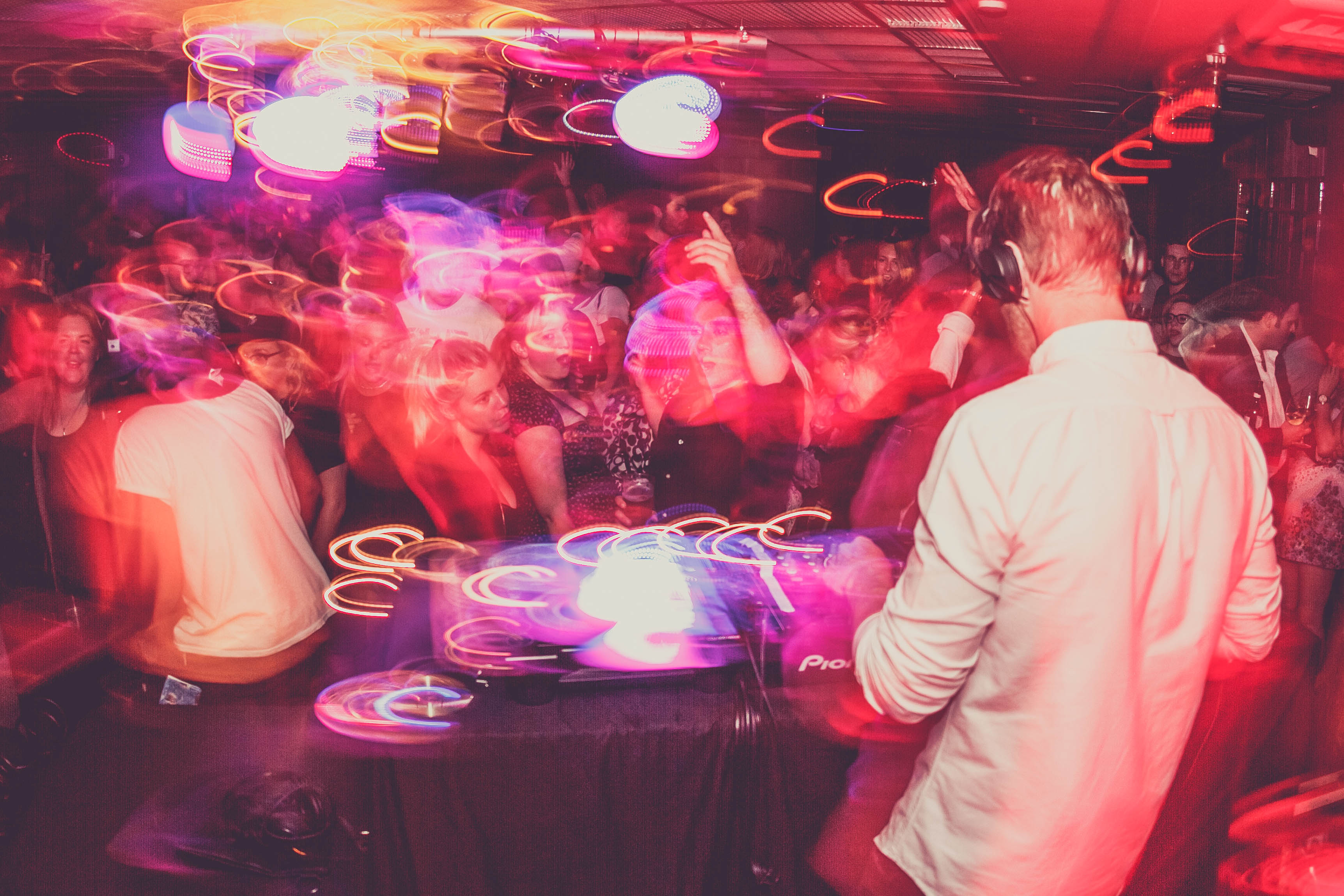 Vibrant DJ performance at The Basement, Cavendish Square, with dynamic lighting and dancing crowd. - Banner