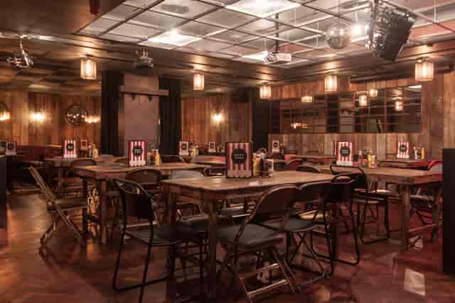 Intimate event space with rustic decor, ideal for networking and workshops.