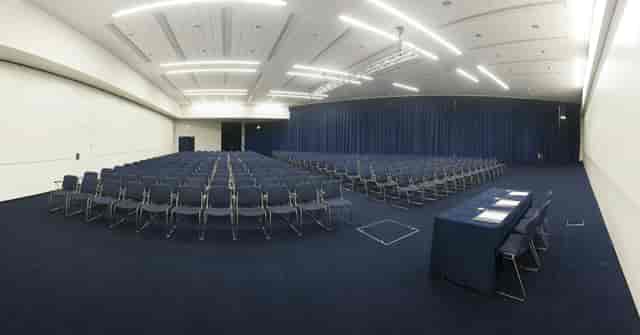 Spacious Charter Suite conference room in Manchester with elegant blue curtains.