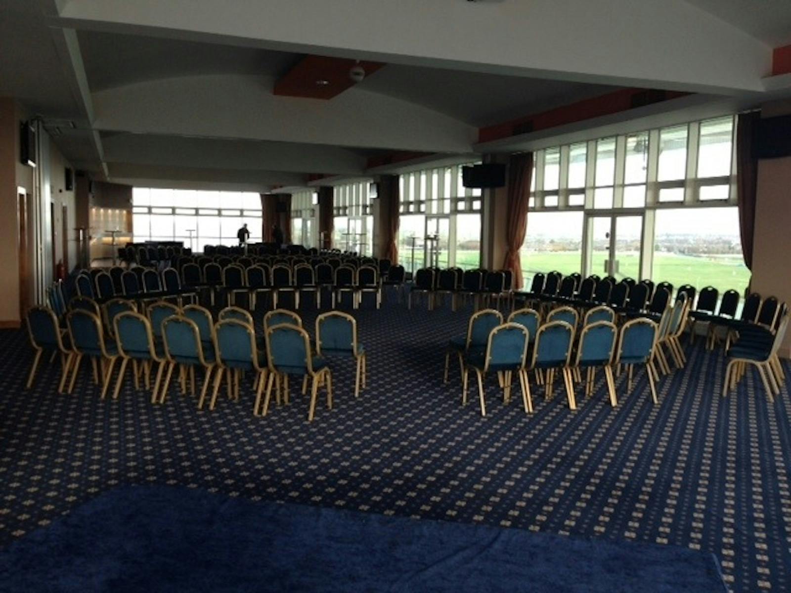 Princess Royal Suite at Aintree Racecourse, spacious meeting venue with blue chairs.