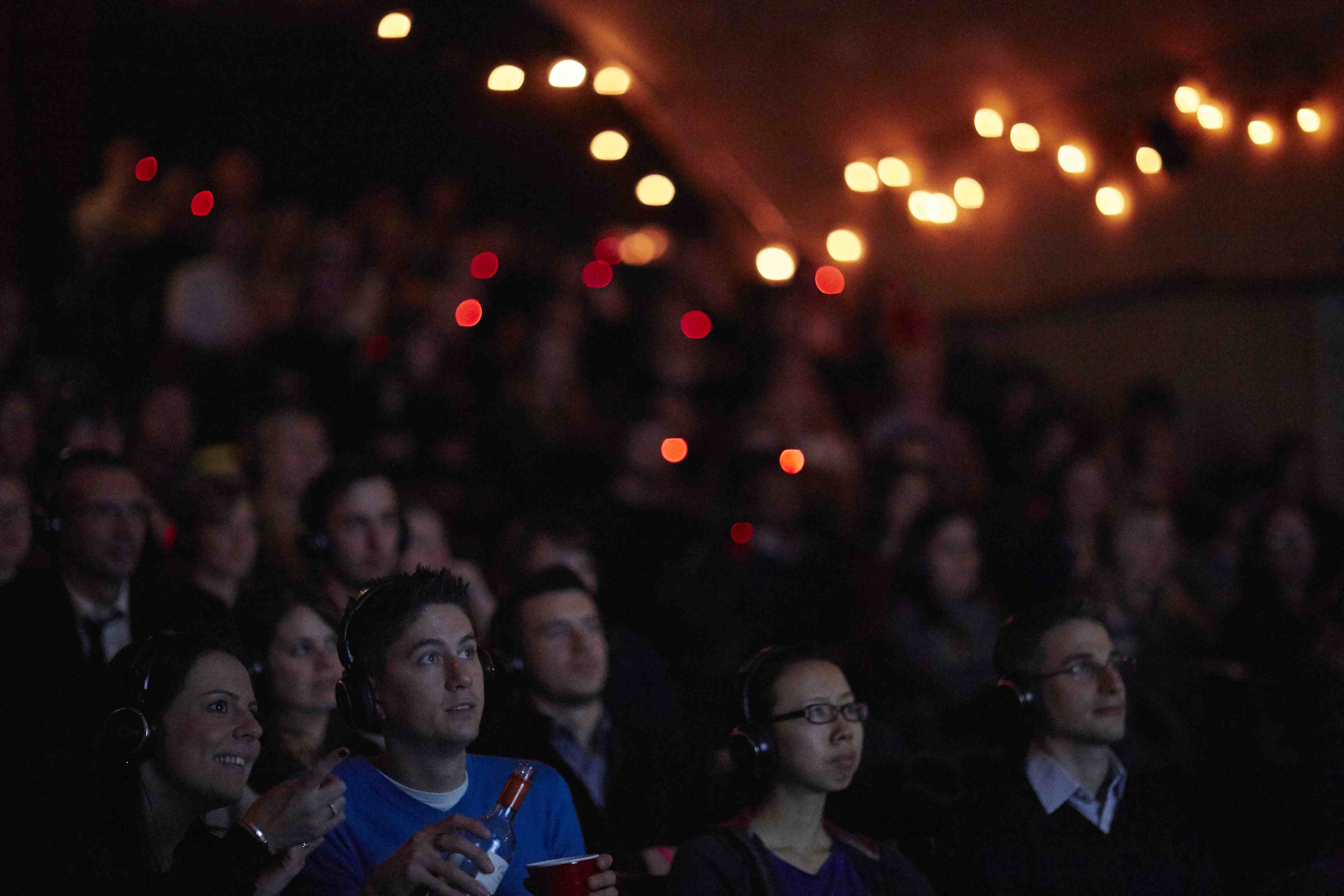 Engaged audience at The Vaults Theatre during an immersive multimedia event.