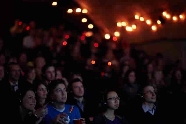 Engaged audience at The Vaults Theatre during an immersive multimedia event.