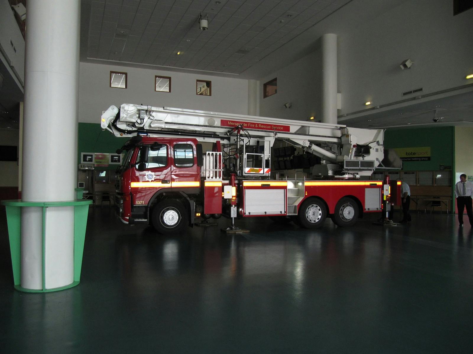 Fire truck in Aintree Racecourse Exhibition Hall for safety event preparedness.