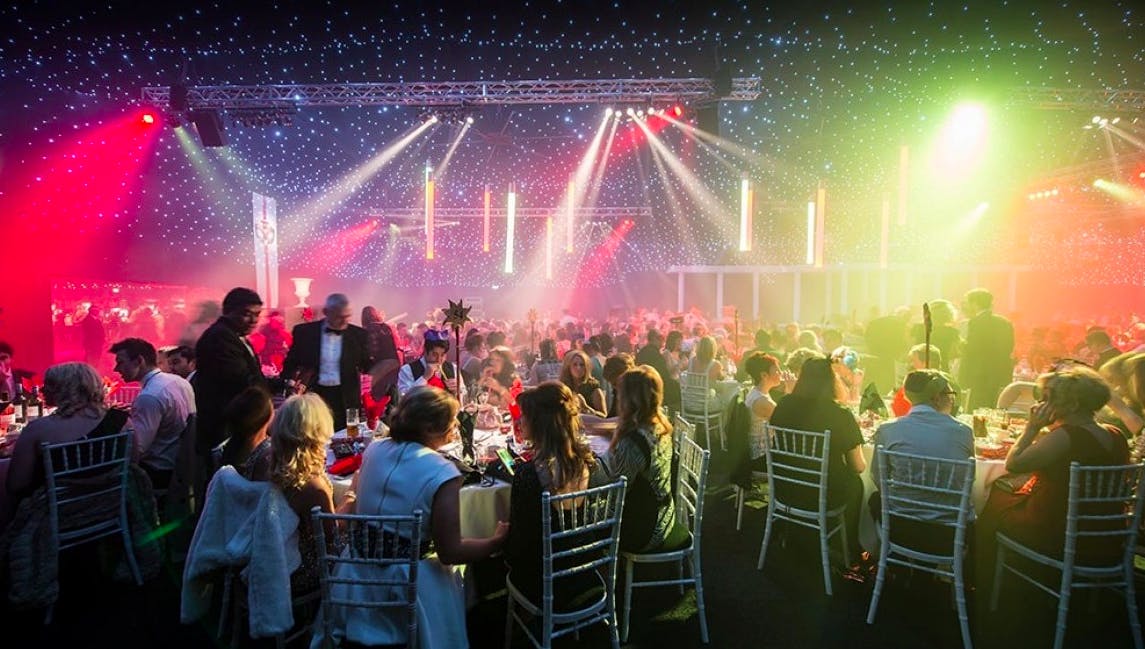 Aintree Racecourse Equestrian Centre event space with elegant tables and vibrant atmosphere.