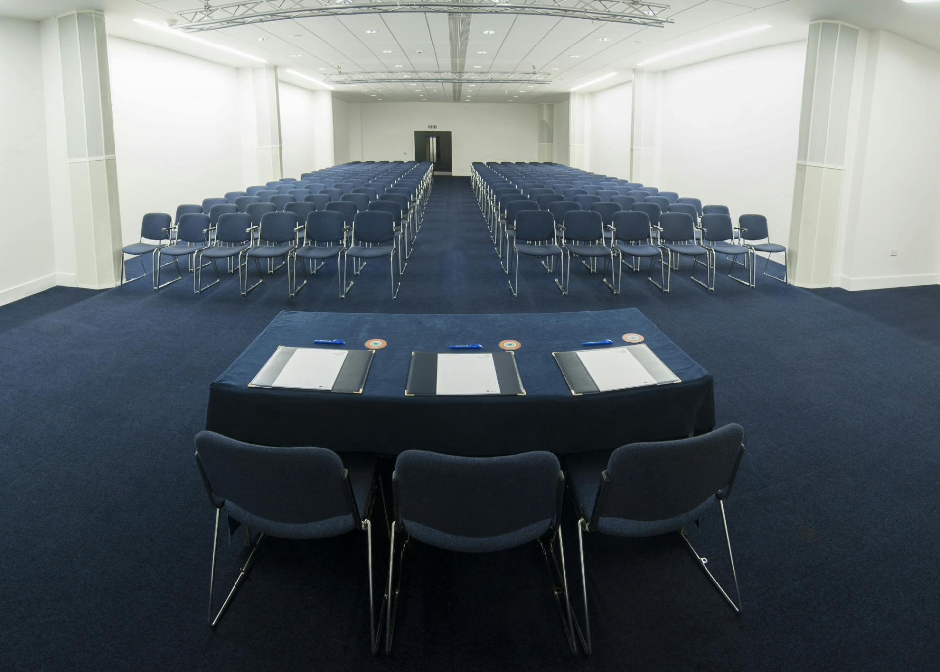 Spacious conference room in Manchester Central with arranged chairs for seminars.