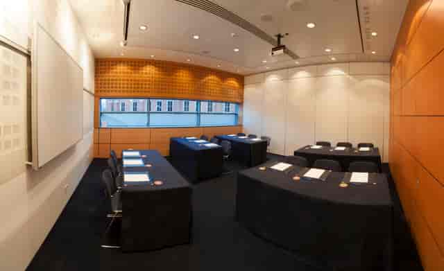 Meeting room in Manchester Central with U-shaped tables for professional gatherings.