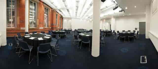 Exchange Room 11 in Manchester Central, featuring round tables for meetings and workshops.