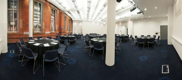 Exchange Room 11 in Manchester Central, featuring round tables for meetings and workshops.