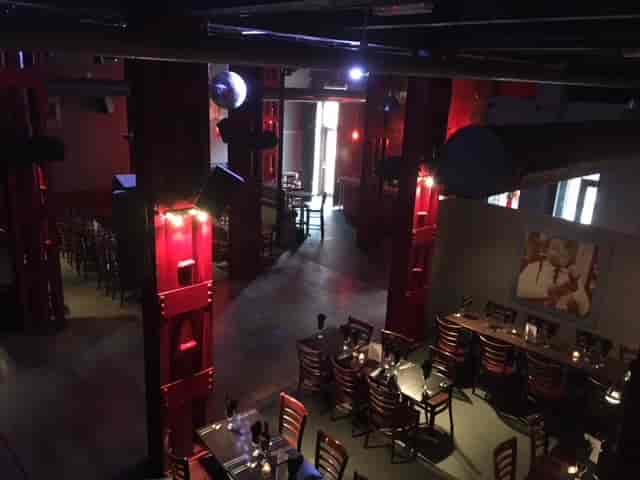 Spacious Blundell Street event venue with red pillars for corporate meetings and social gatherings.
