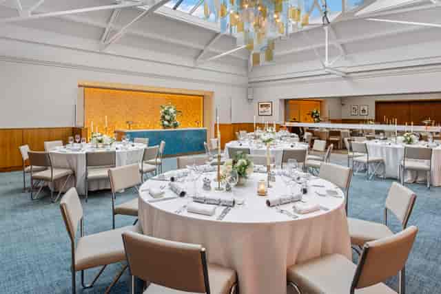 Elegant event space in Bluebird Chelsea with round tables and natural light.