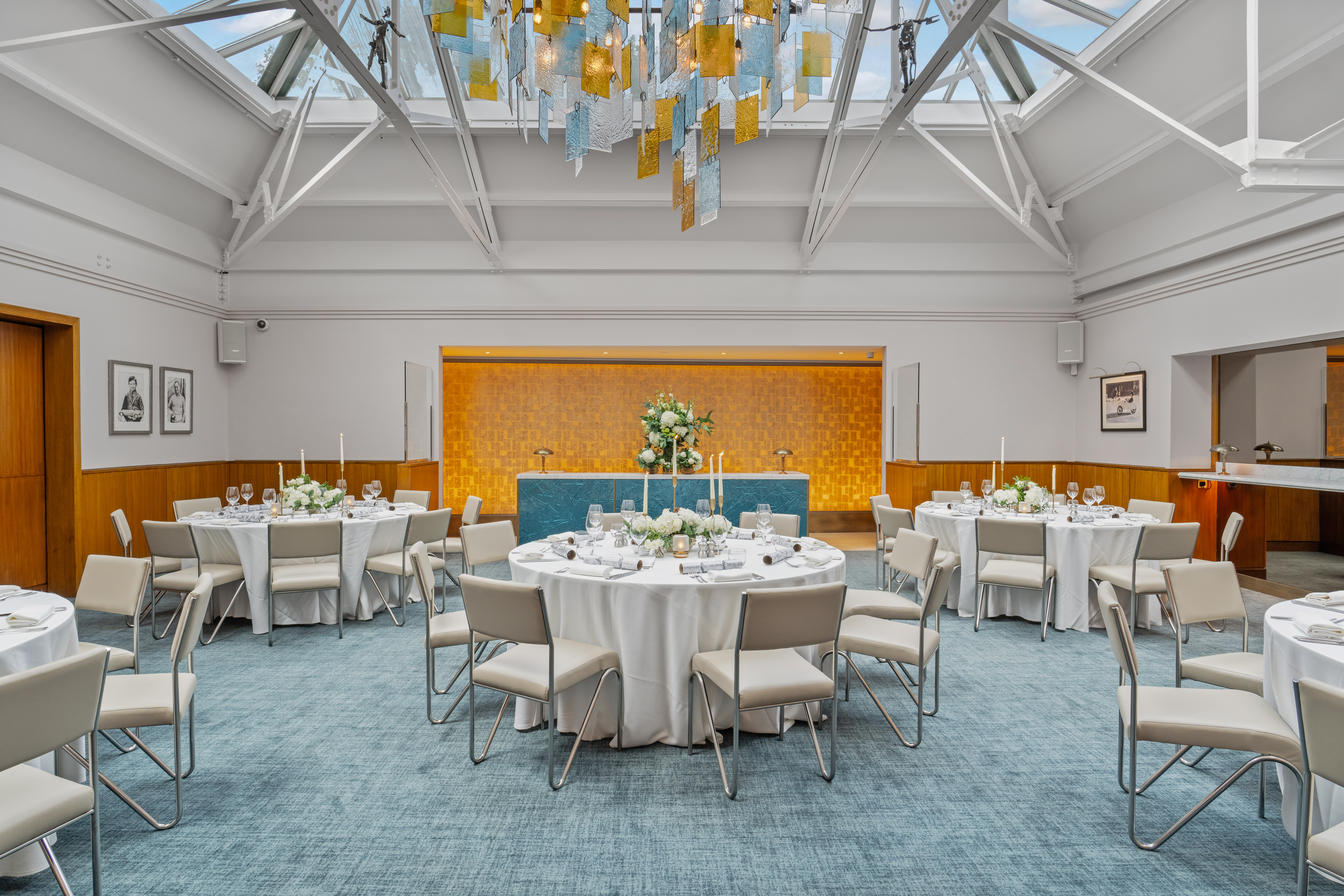 Elegant event space in Bluebird Chelsea with round tables, ideal for weddings and corporate meetings. - Banner