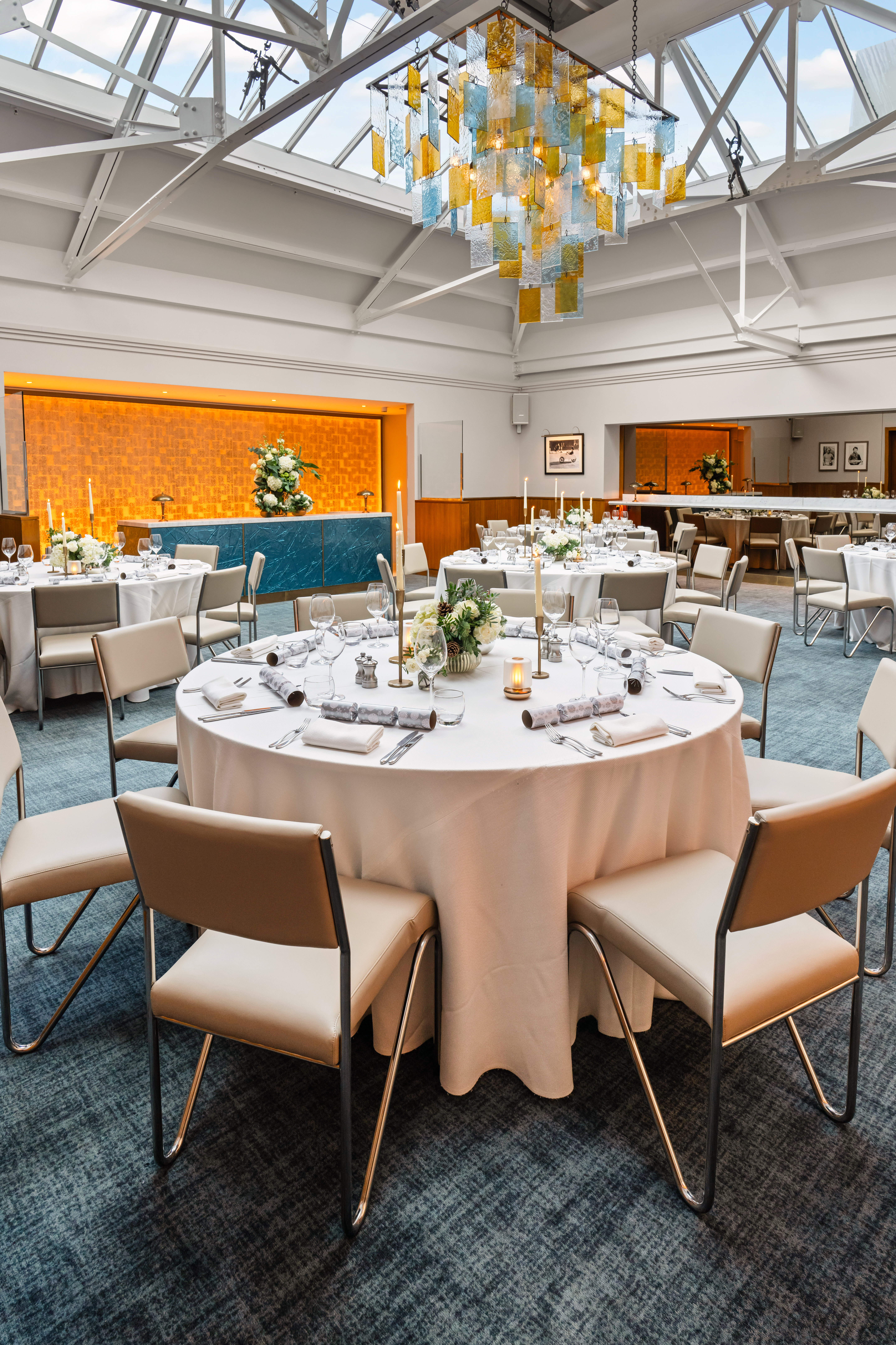 Elegant event space in Bluebird Chelsea with round tables and warm ambient lighting. - Banner