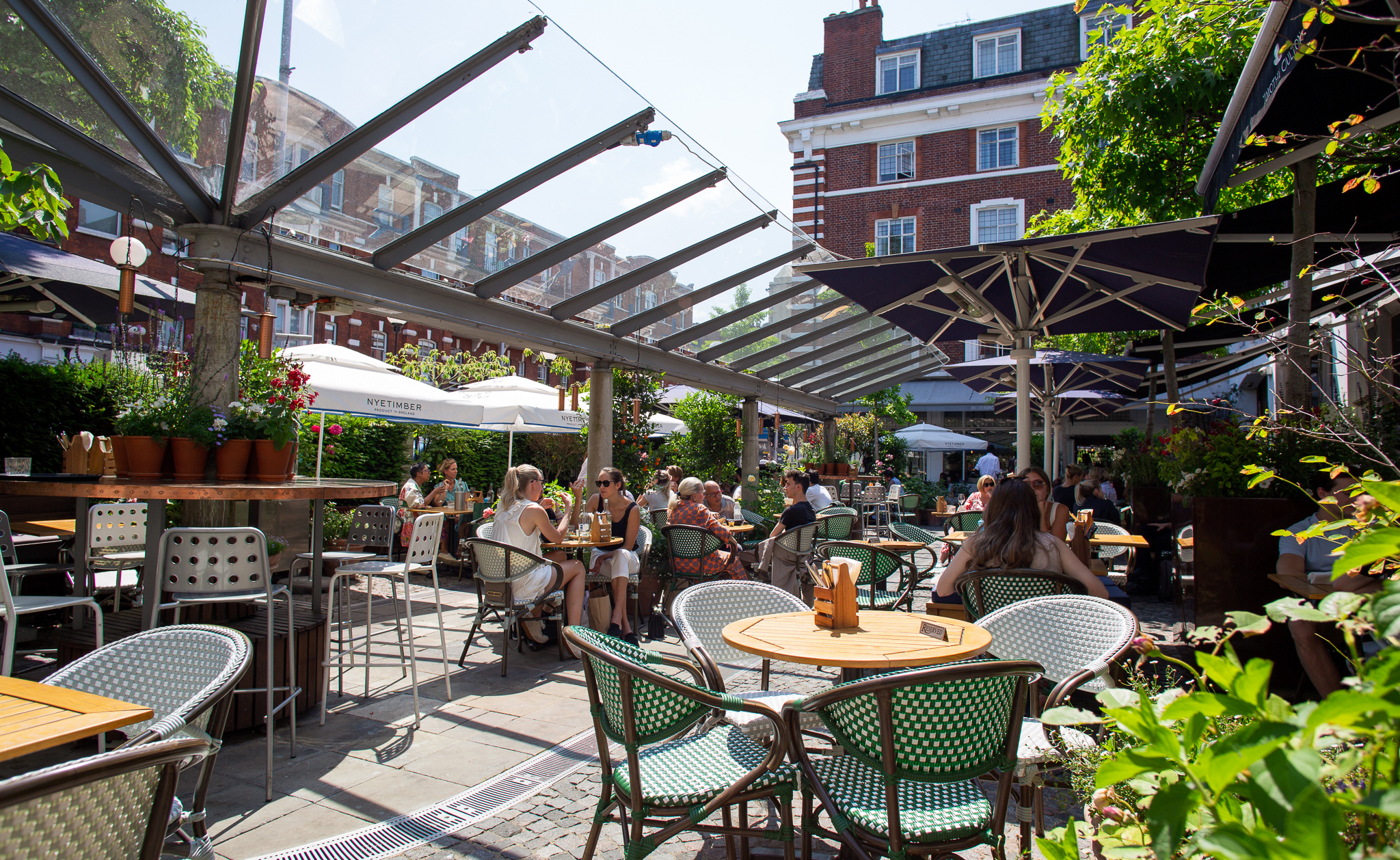 Vibrant outdoor venue at Bluebird Chelsea, ideal for casual meetings and events. - Banner