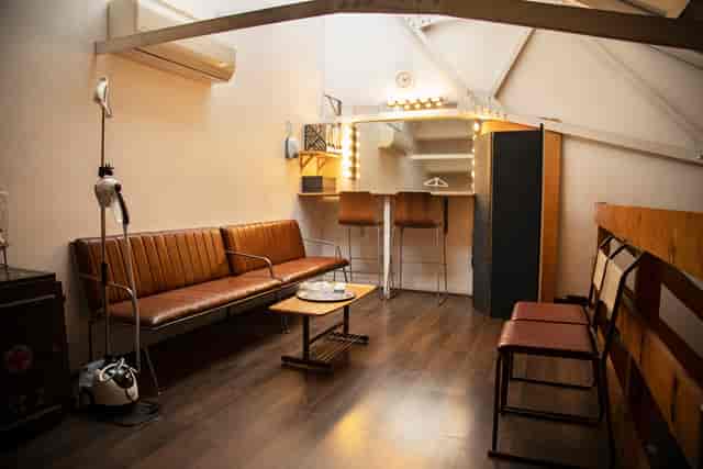 Stylish event preparation area with modern vanity and warm lighting in Espero Studio.