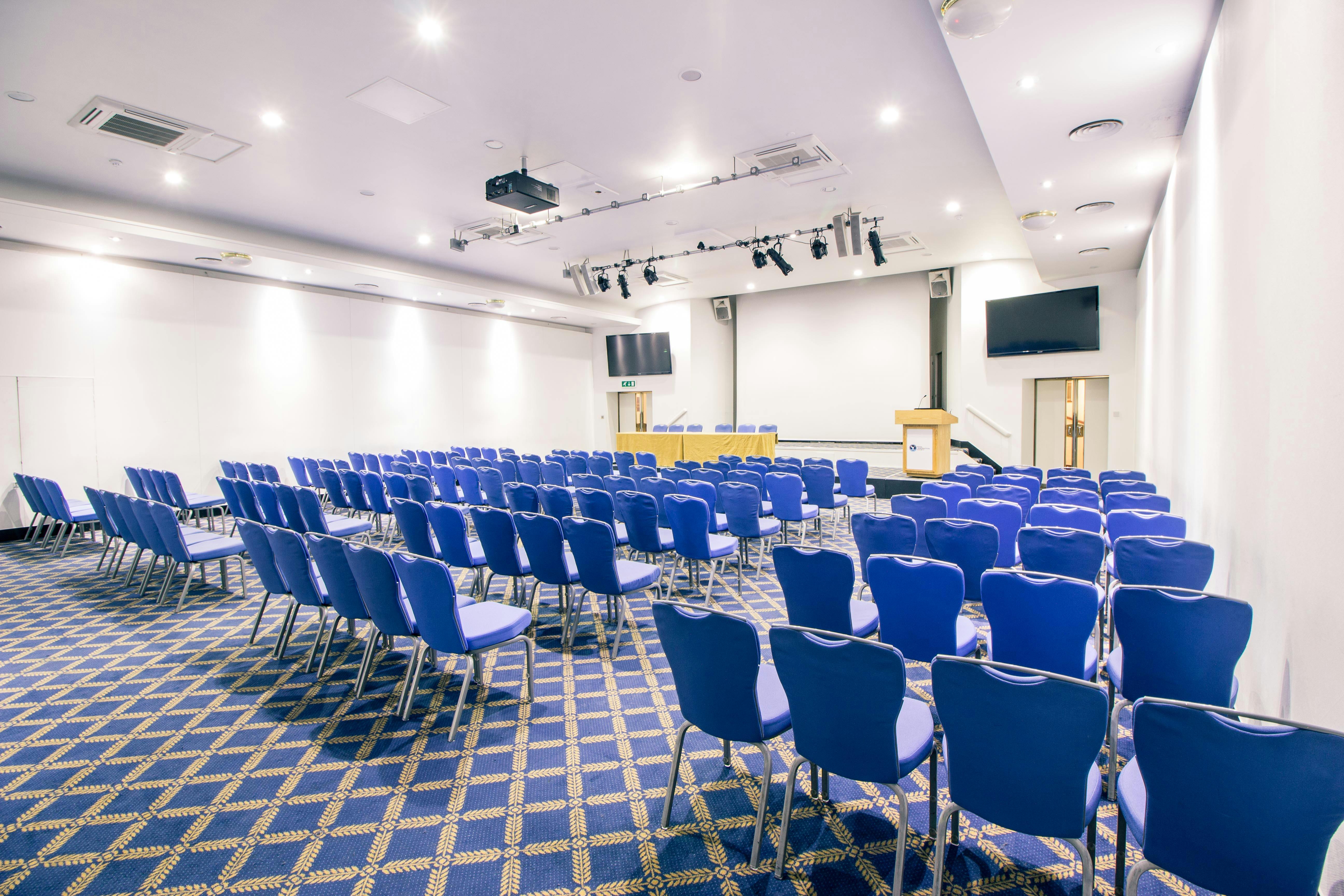 Bill Boeing Room conference setup with blue chairs for presentations and events.