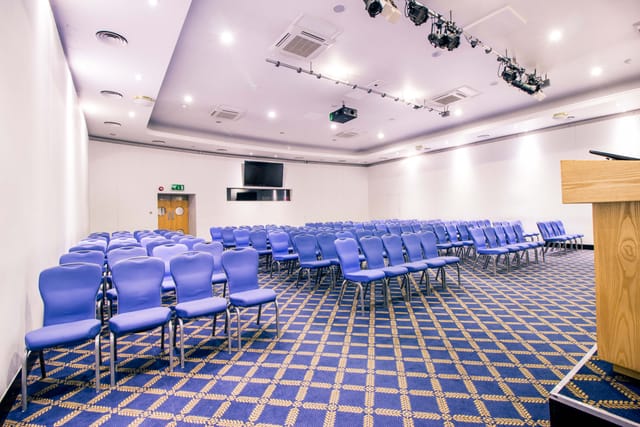 Bill Boeing Room with blue chairs, ready for a conference or seminar event.