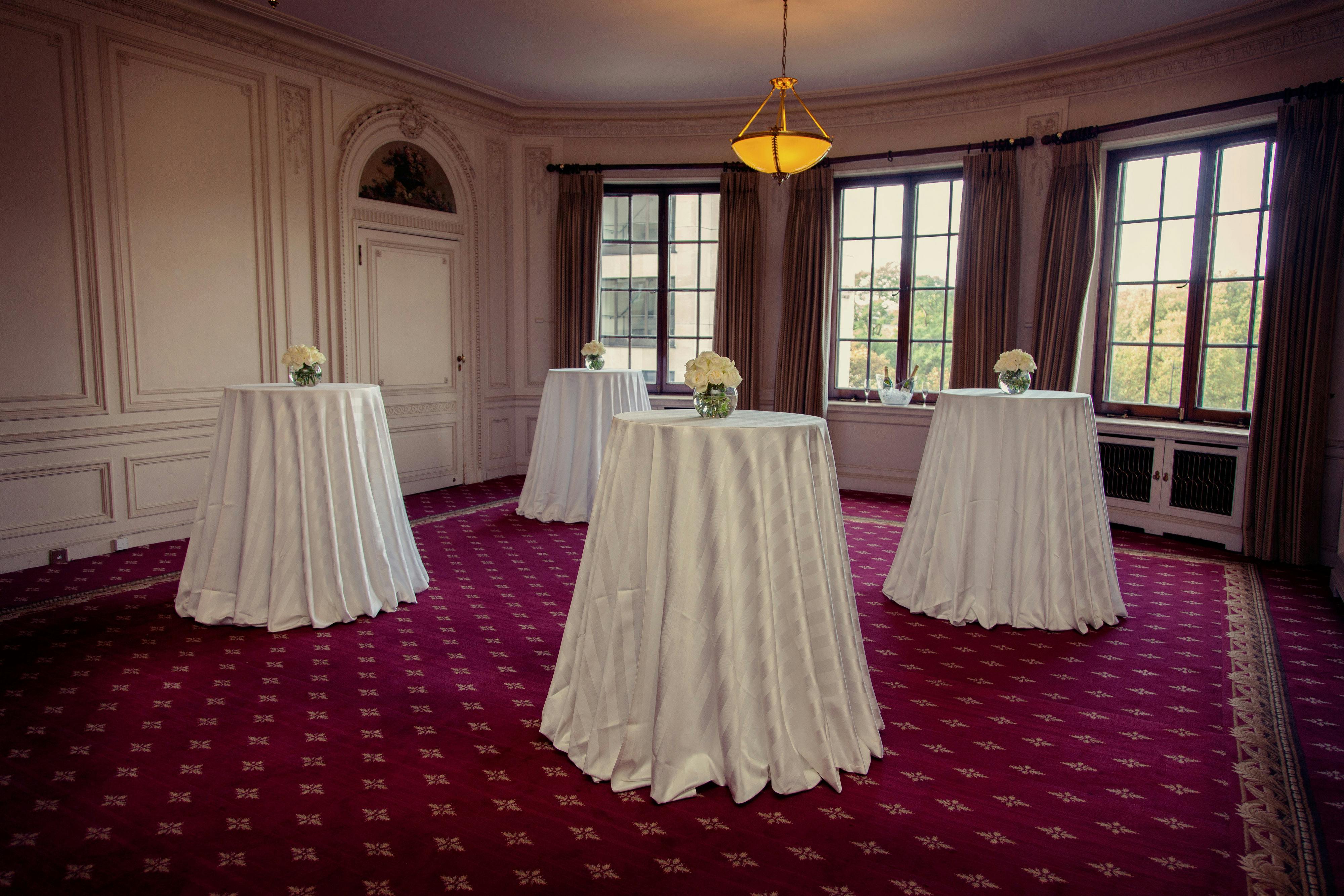 Elegant Handley Page Room with floral centerpieces, perfect for networking events.