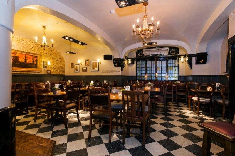 Marthas Cellar Bar dining space with wooden tables, perfect for private events and gatherings.