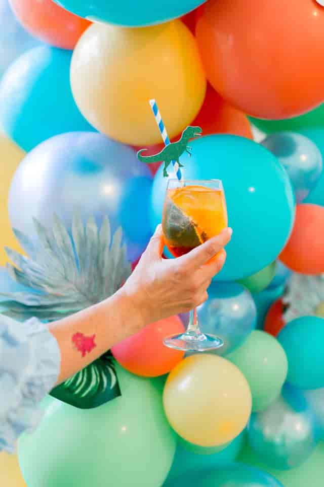 Vibrant cocktail with dinosaur garnish at London Museum Spaces for themed events.