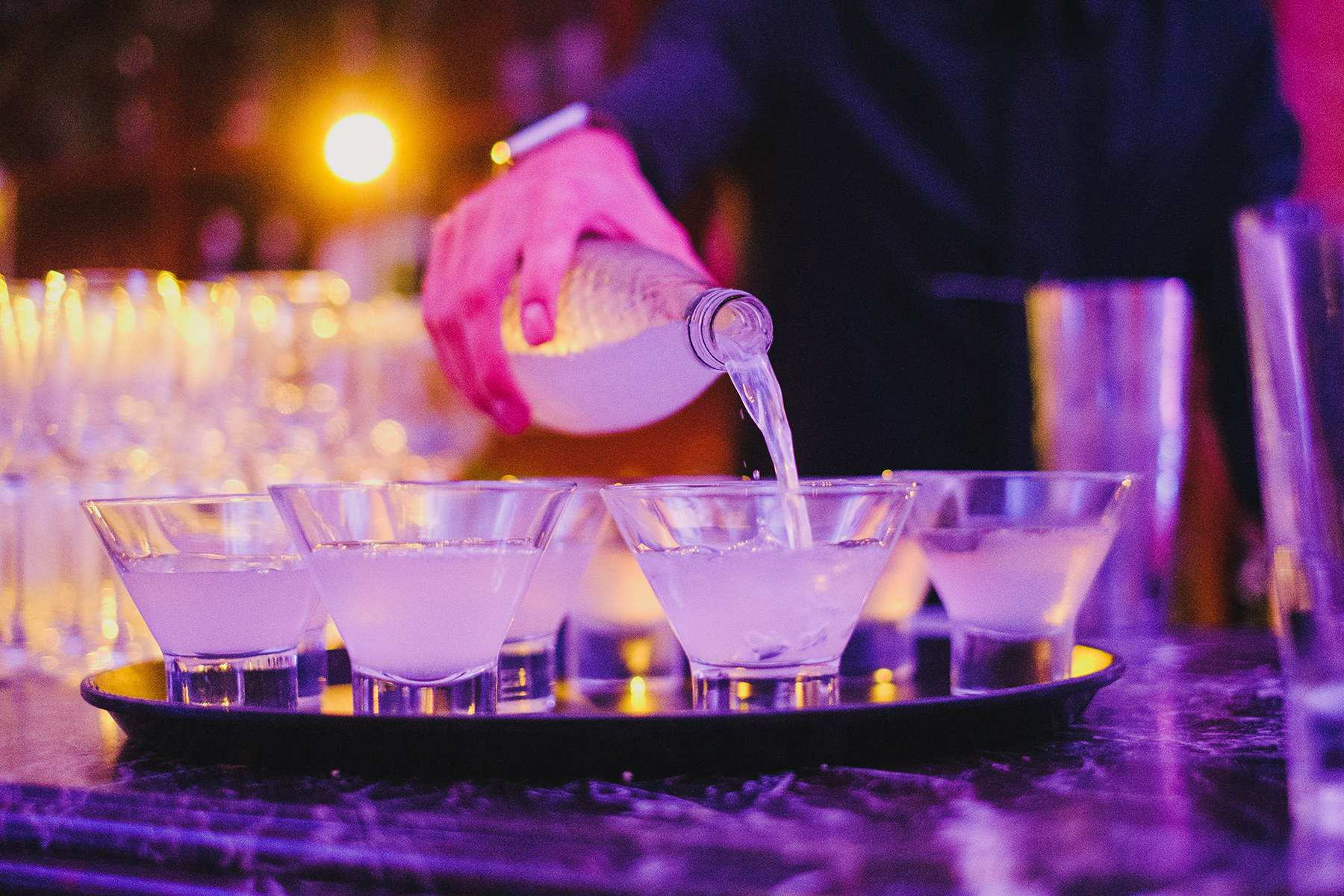 Bartender pouring drinks at London Museum Spaces for a sophisticated event. - Banner