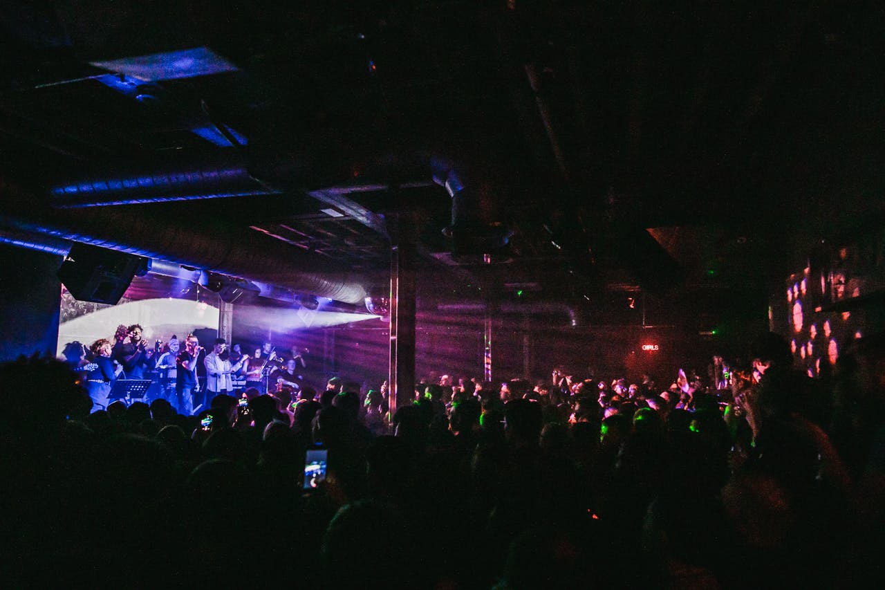 Vibrant XOYO event space with dynamic lighting for concerts and corporate networking.