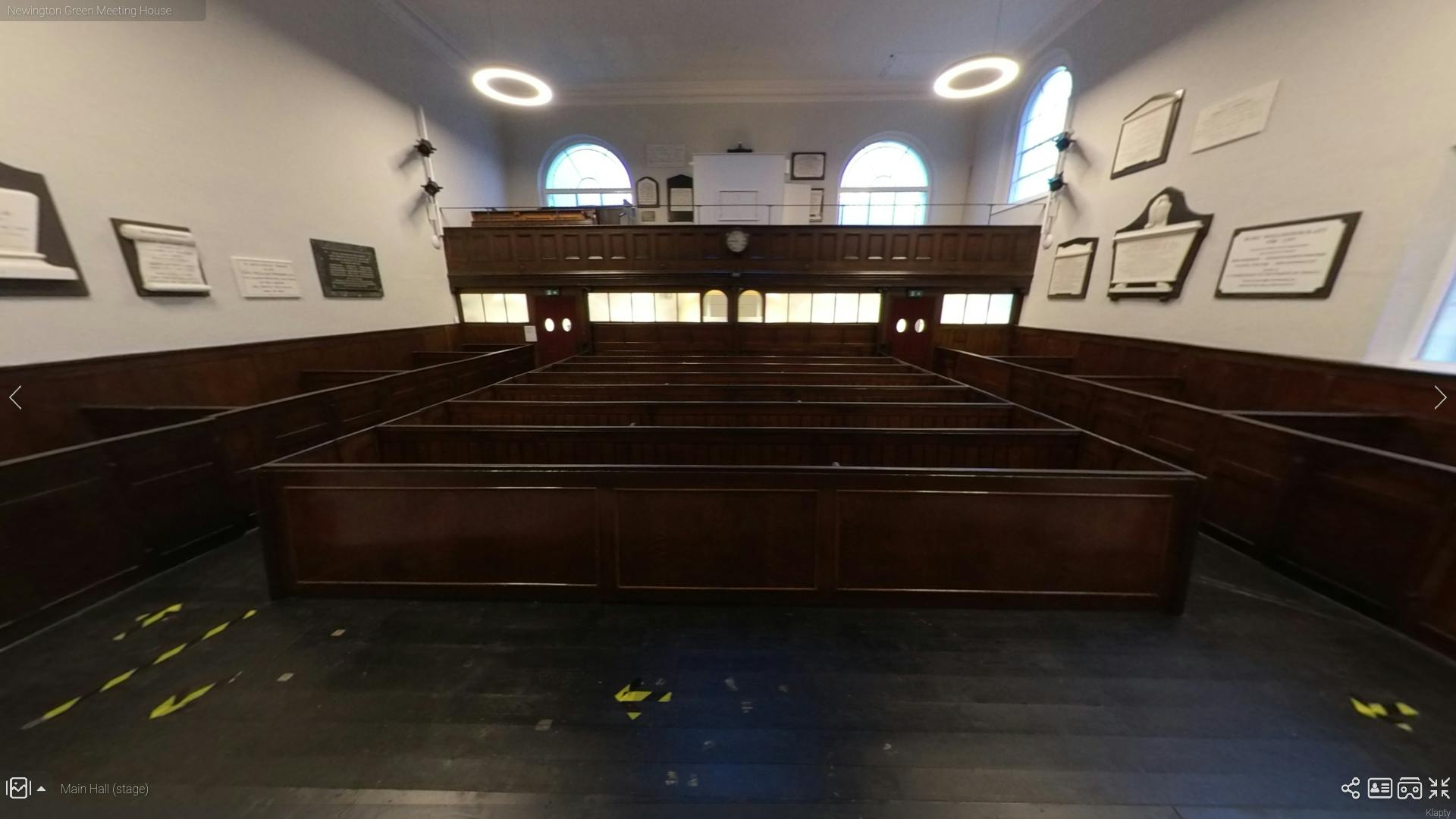 Historic Newington Green Meeting House with wooden benches, ideal for intimate gatherings.