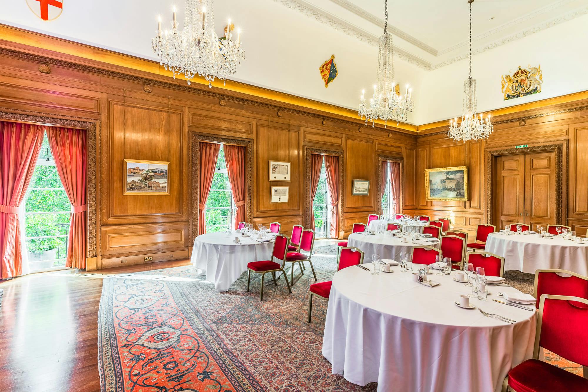 Elegant meeting room with wooden paneling, ideal for formal events and upscale gatherings.