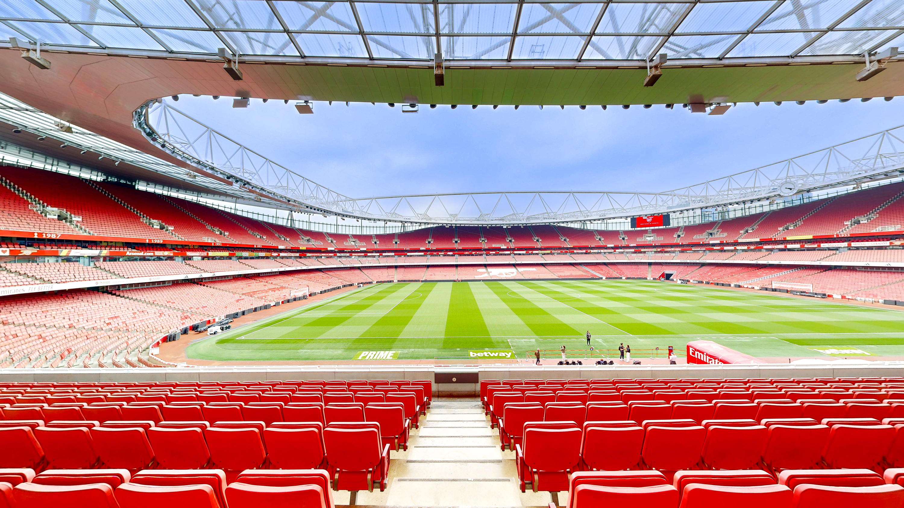 Highbury at Emirates Stadium with red seating, ideal for sports events and concerts. - Banner