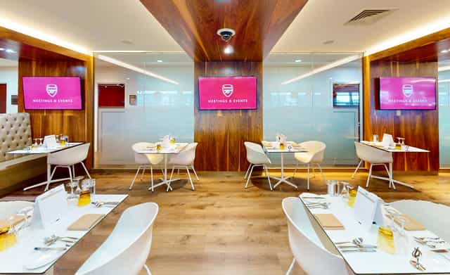 Modern meeting space at Arsenal's Emirates Stadium with sleek furniture for corporate events.
