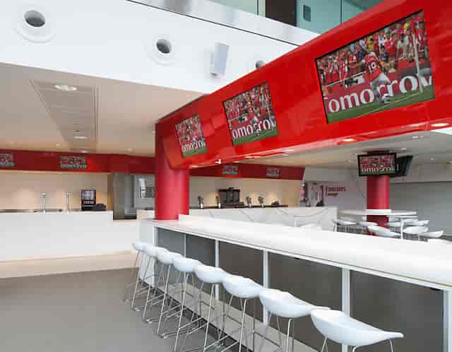 Emirates Lounge at Arsenal FC: modern event space with bar seating for networking events.