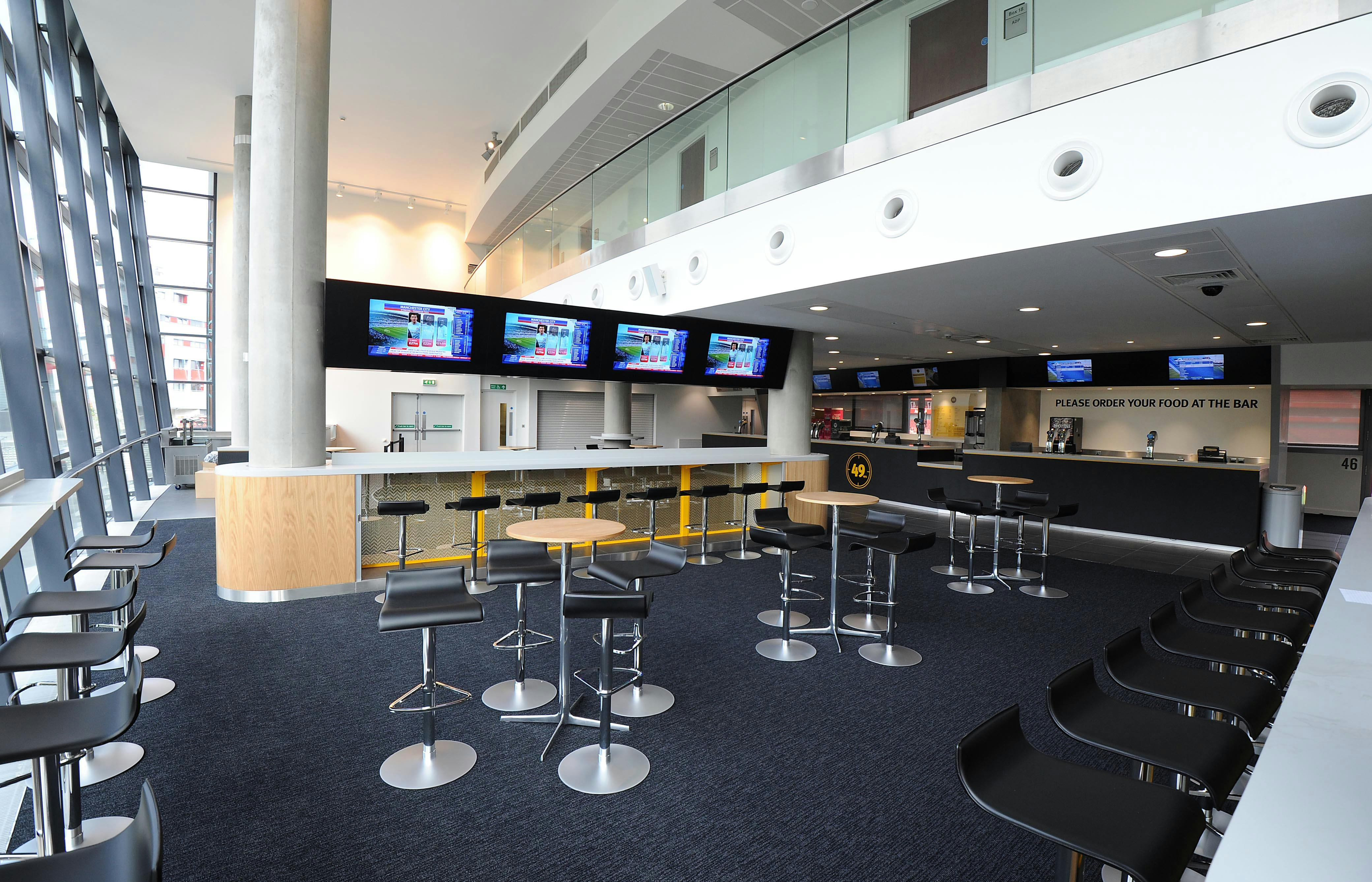 49ers event at Emirates Stadium with sleek bar area and natural light for networking.