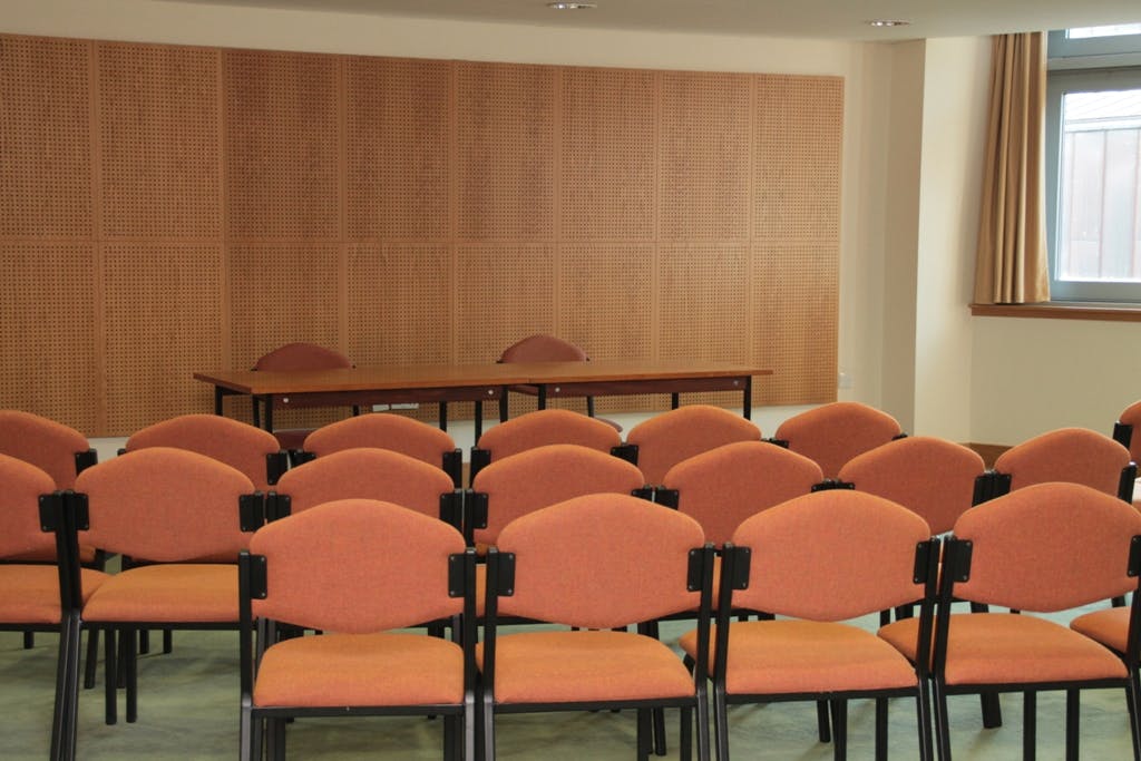 Institute Room in Liverpool Quaker Meeting House with orange chairs for meetings and discussions.