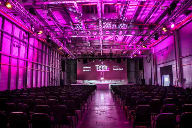 Event space at Reel Storage, Printworks London, with purple lighting for a tech conference.