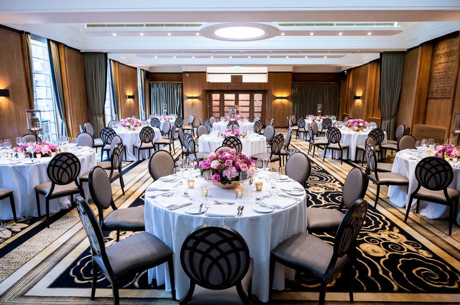 Elegant event space in Hall of India with floral centerpieces for corporate meetings.