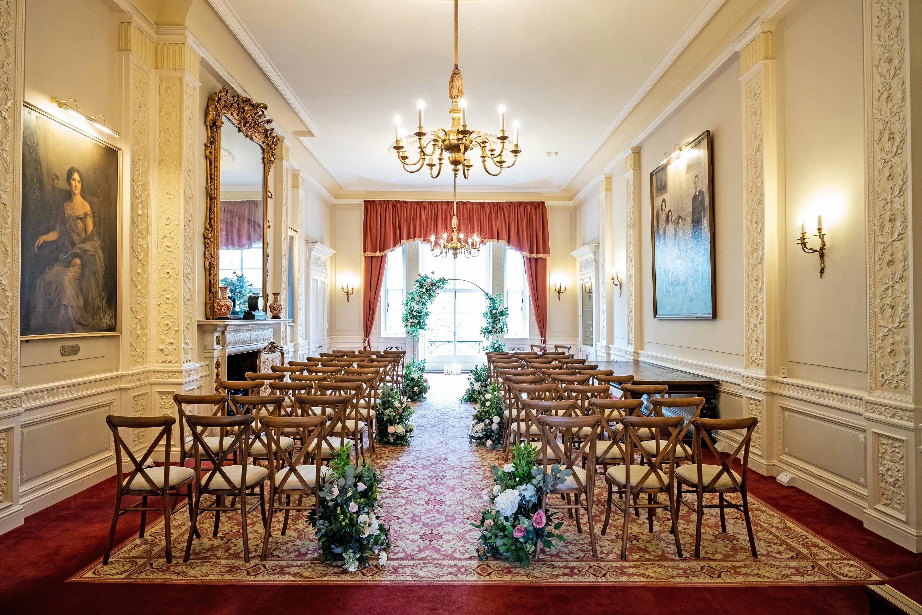 Elegant wedding venue with floral arrangements and classic chandeliers at Six Park Place.