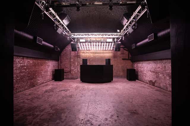 Versatile event space at Ministry of Sound with exposed brick, ideal for concerts and corporate events.