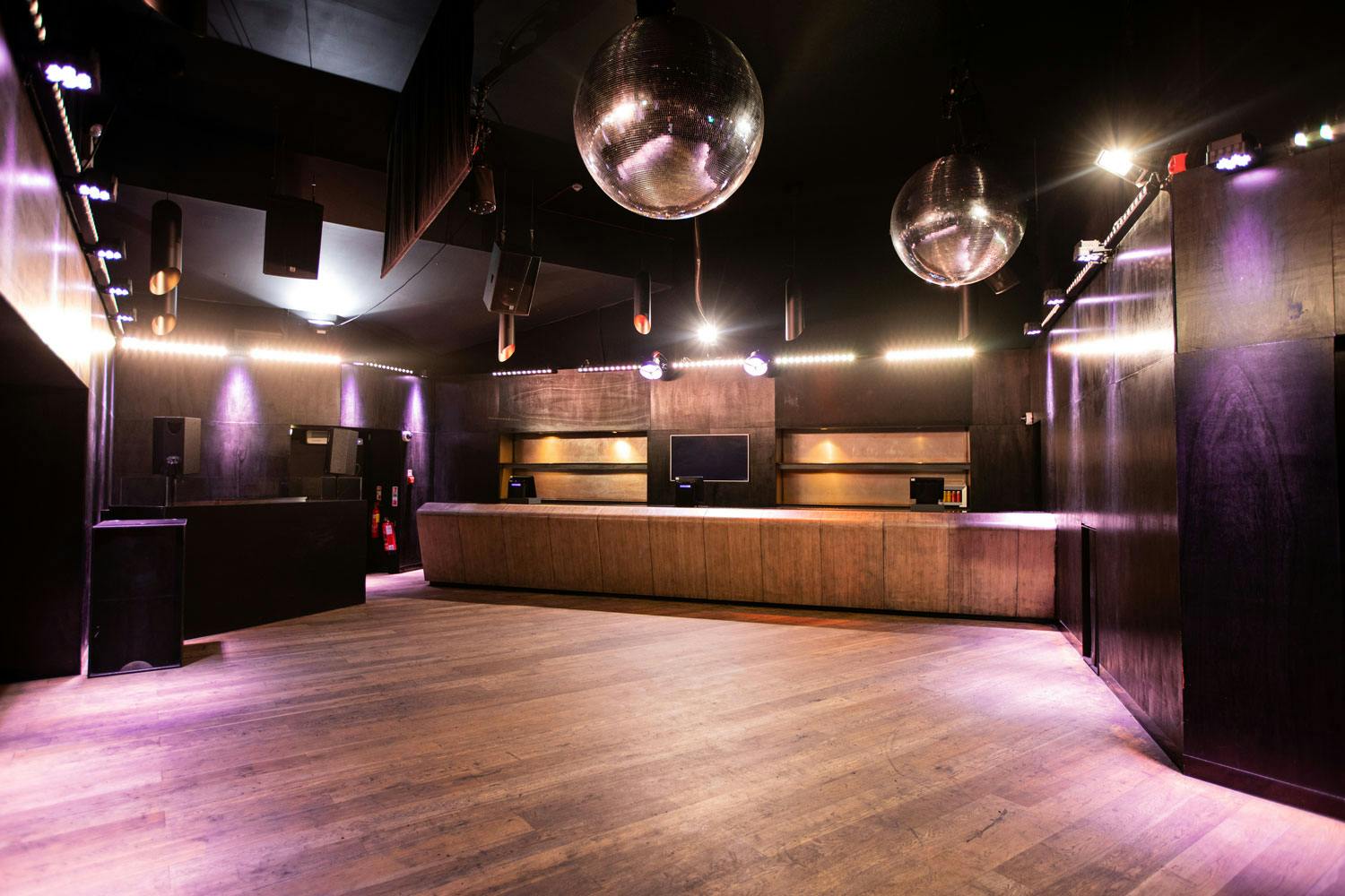 Modern event space at The Loft, featuring polished wooden floors for parties and networking.