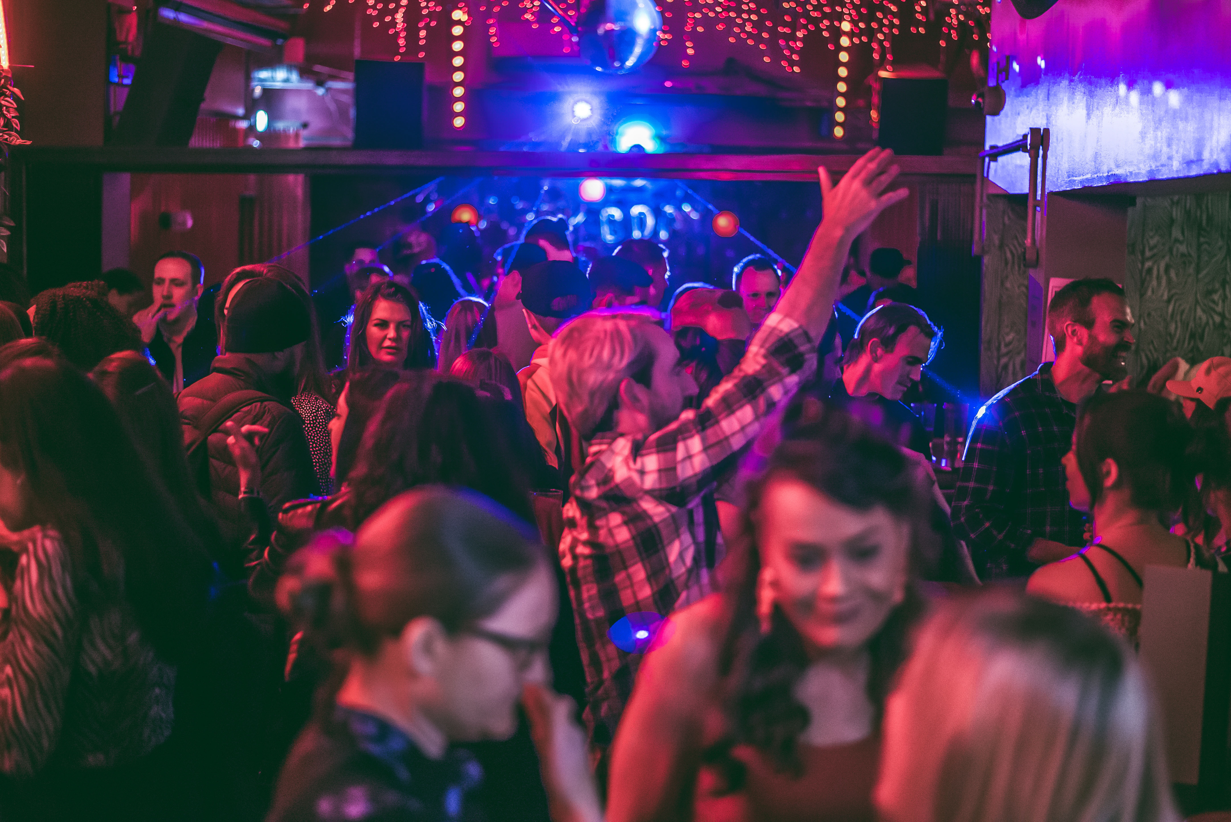 Vibrant event venue at The Big Chill with dynamic lighting and lively crowd.