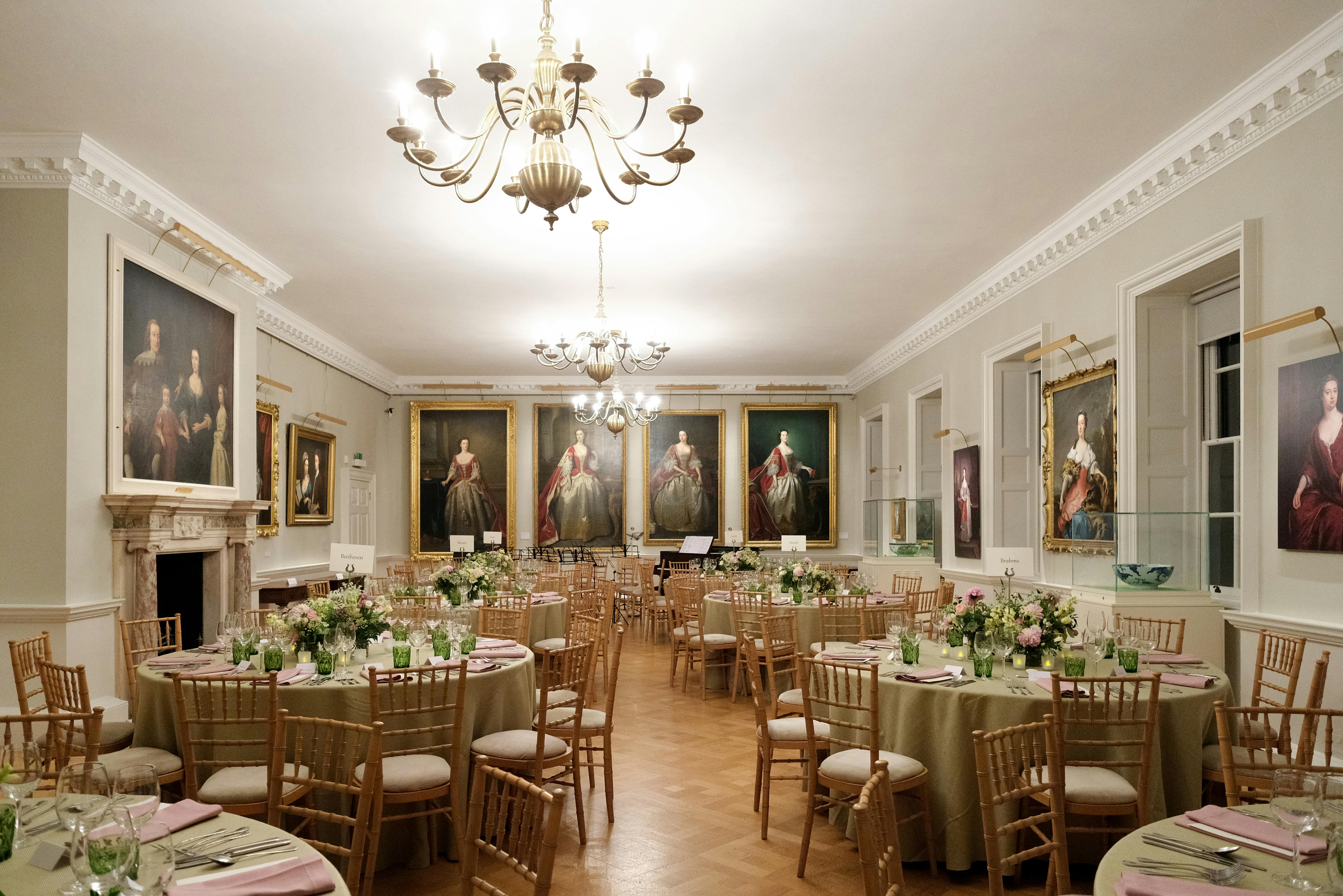 Elegant dining room with floral centerpieces for upscale events at The Foundling Museum.