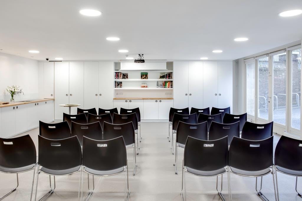 Clore Creative Studio meeting space with black chairs, ideal for workshops and conferences.